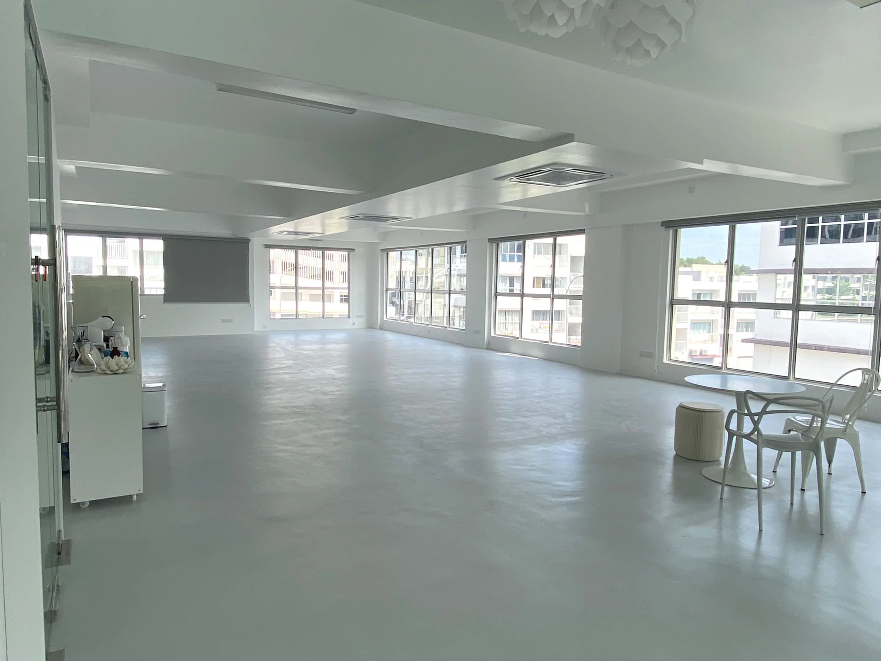 The open white and grey venue, with large windows along two sides.